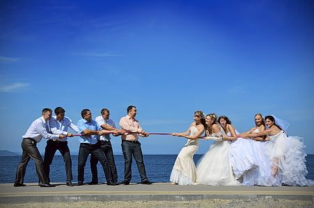 bride and groom acting playing tug of war thumbnail