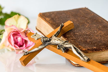 crucifix and bible on table thumbnail