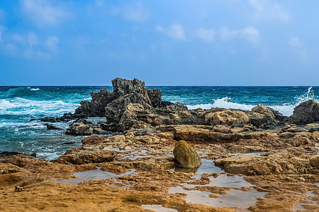 gray stone formation near body of water during daytime thumbnail
