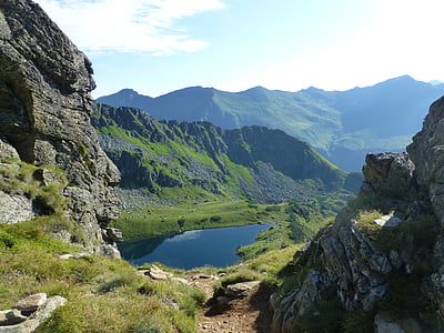 top view of green mountain beside lake thumbnail