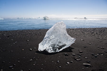 clear ice on black sand seashore thumbnail