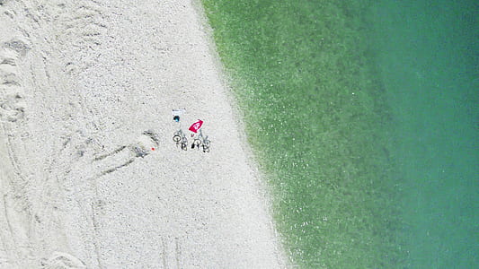 aerial photo of two bicycles on seashore at daytime thumbnail