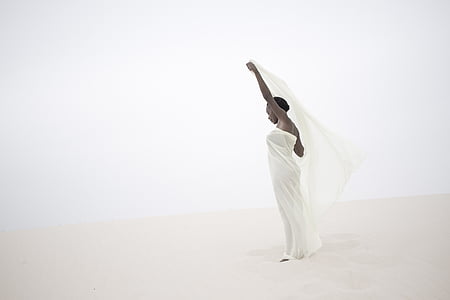woman wearing white spaghetti strap dress holding white shawl thumbnail