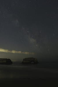 gray rock formation on body of water thumbnail