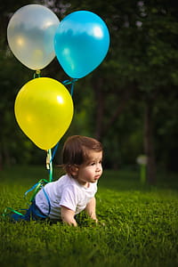 Baby Wearing White Shirt Tied With Three Balloons thumbnail