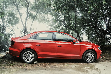 Red Sedan Near Green Trees during Day Time thumbnail
