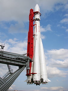 white and red rocket under blue and white sky at daytime thumbnail