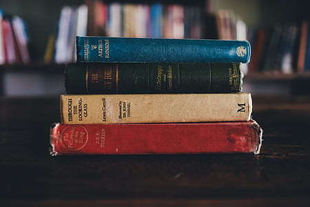 four assorted-title books on table thumbnail