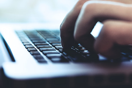 Closeup shot of a person typing on a laptop computer keyboard thumbnail