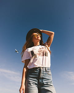 woman standing under airliner on mid air thumbnail