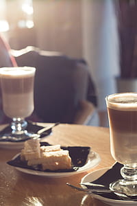 two full footed glasses and pastry on table thumbnail