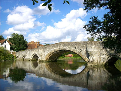 gray concrete bridge above calm body of water at daytime thumbnail