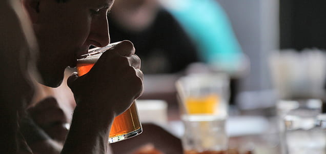 shallow focus photography of person drinking brown liquid thumbnail
