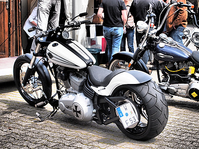 white and black cruiser motorcycle parked near outdoors thumbnail
