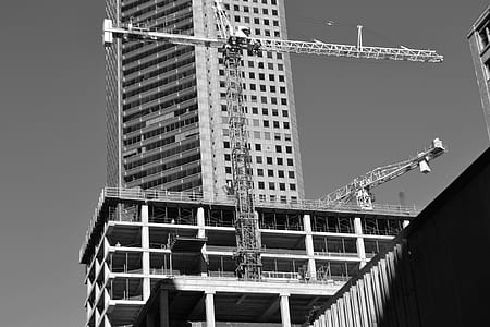 grayscale photography of building heavy equipment thumbnail