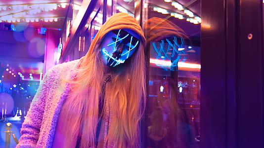 woman wearing LED mask while taking selfie thumbnail