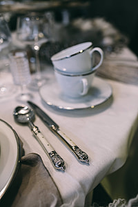 Fancy restaurant dinner table decorated with quail eggs and feathers thumbnail