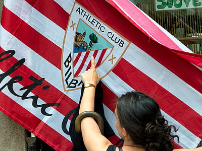 person pointing at flag thumbnail