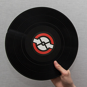 person holding vinyl record disc thumbnail
