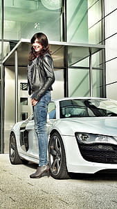 woman stands beside white car thumbnail