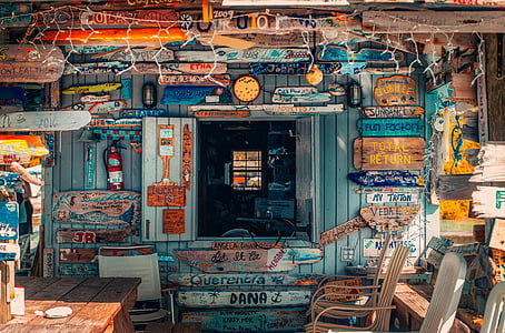 blue wooden house with string lights and chairs thumbnail