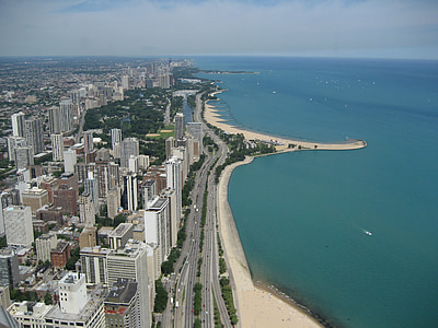 aerial photography of high rise buildings beside body of water thumbnail