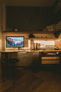 powered-on silver iMac on desk thumbnail