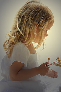 girl in white dress holding flowers thumbnail