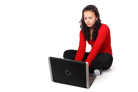 woman wearing red long-sleeve shirt and black pants on squat beside laptop thumbnail