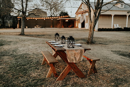rectangular brown wooden picnic table with plates thumbnail
