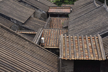 low-angle photography of brown building roofs at daytime thumbnail