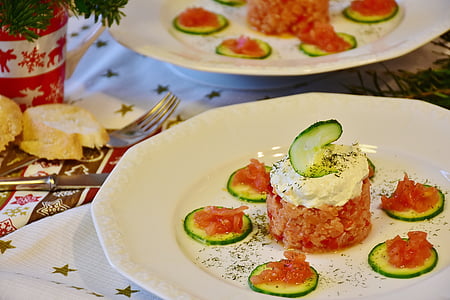 sliced cucumbers with cream on white ceramic plate thumbnail
