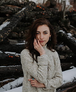 close-up photography of woman wearing brown knit sweatshirt during daytime thumbnail