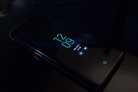 turned on Android smartphone on black surface thumbnail