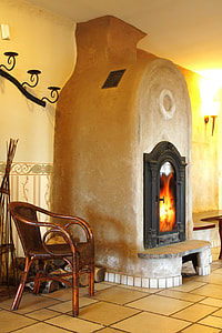 brown wooden armchair beside fireplace thumbnail