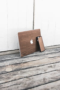 MacBook Air and iPhone with brown wood skins on floor thumbnail