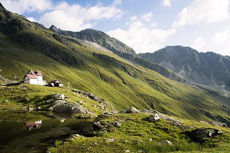 white and brown house near the mountain photography during daytime thumbnail