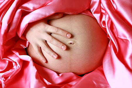human hand touching stomach thumbnail