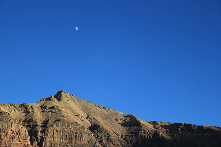 brown mountain under blue sky and moon thumbnail