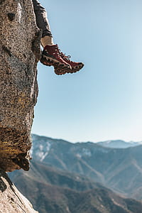 person sitting on top of mountain at daytime thumbnail