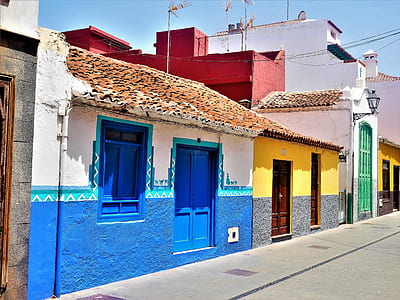 white, blue, and yellow concrete houses thumbnail