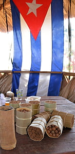 brown and gray warps on gray table near Cuba flag at daytime thumbnail