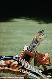 shallow focus photography of assorted arrows and bows thumbnail