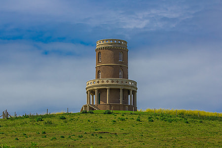 round beige and brown concrete structure on grass field thumbnail