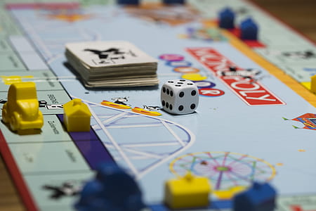 selective focus photography of Monopoly board game with dice and playing card thumbnail