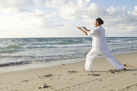 man wearing white top on beach during daytime thumbnail