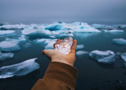 person holding clear stone thumbnail