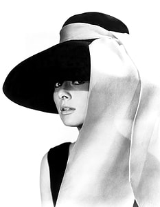 woman in black sleeveless dress and black hat photo thumbnail