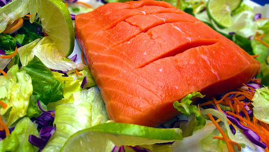orange fish meat on green vegetables thumbnail