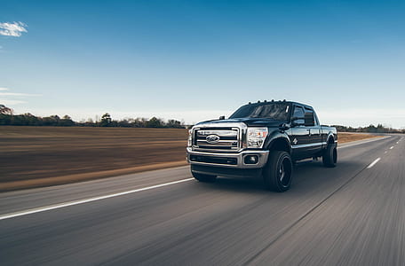 black Ford F-250 crew cab pickup truck on road during daytime thumbnail